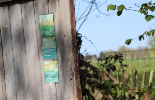 a building with signs on the side of it at Glamping Zonnebloem - Back-to-Nature in Herzele