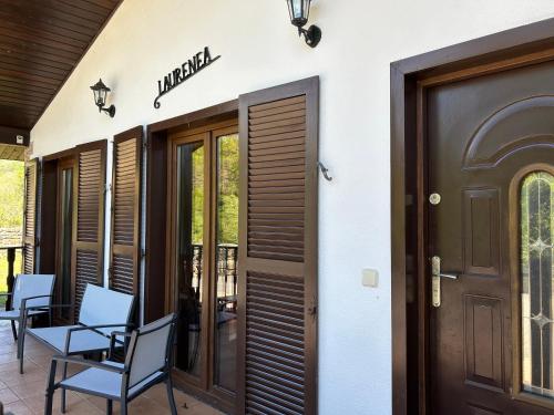 a patio with chairs and a door to a building at Casa Rural Laurenea in Alzate
