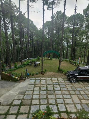 a car parked next to a park with a playground at In the woods homestay Lansdowne in Lansdowne