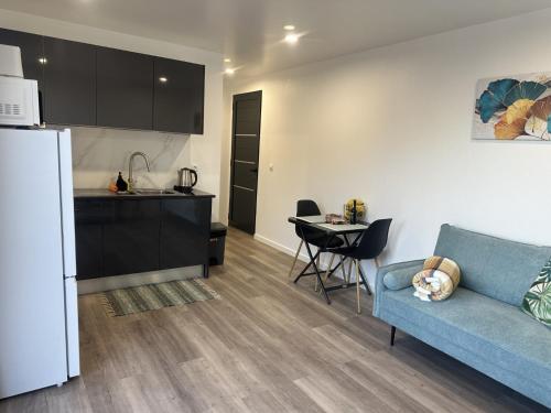 a kitchen and a living room with a couch and a table at Pearl Of The Sea in Ponta do Sol