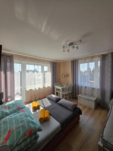 a bedroom with a bed with yellow shoes on it at u eli i jurka in Sztutowo