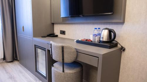 a kitchen with a desk with a coffee maker on it at Optimal Hotel in Bursa