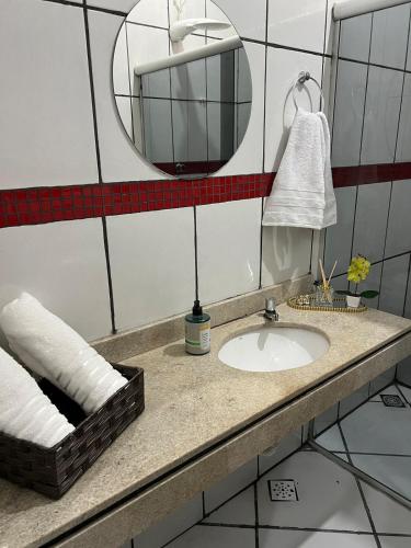 a bathroom with a sink and a mirror at Casa do umbuzeiro in Bom Jesus da Lapa