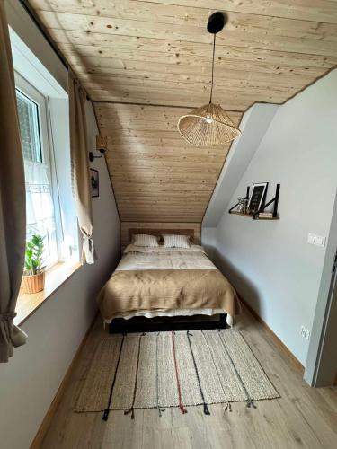 a bedroom with a bed in the corner of a room at Chata Bławatek Kowary in Kowary