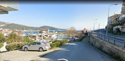 a car parked in a parking lot next to a street at Blue Lagoon 3 in Kavala