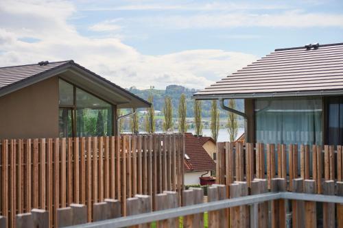 a wooden fence in front of a house at Bodensee Penthouse 23D - Seesicht - Billiard - Massage - Trambolin - BBQ - Tischkicker - Panorama Exklusive in Öhningen
