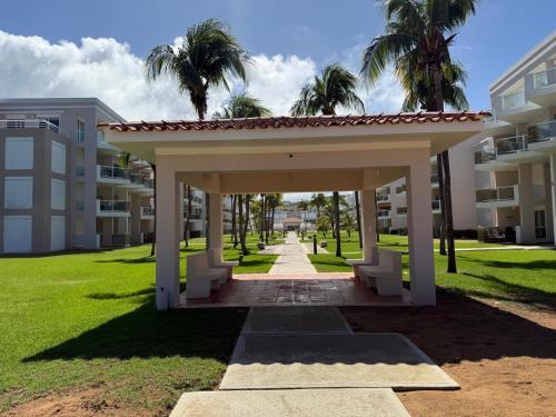a pavilion in front of a building with palm trees at Caribbean Zen at Bosque Del Mar - Las Picuas - Rio Grande in Rio Grande