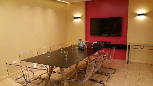 a conference room with a table with chairs and a flat screen tv at Mizpe Yam Boutique Hotel in Netanya