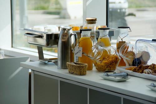 a counter with bottles of honey and food on it at Hotel AS Torrent in Torrent