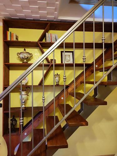 a staircase with wood and metal railings at Serra's House in Serra San Bruno