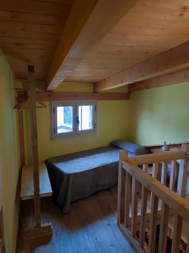 a bedroom with a bed and a staircase in a cabin at Serra's House in Serra San Bruno