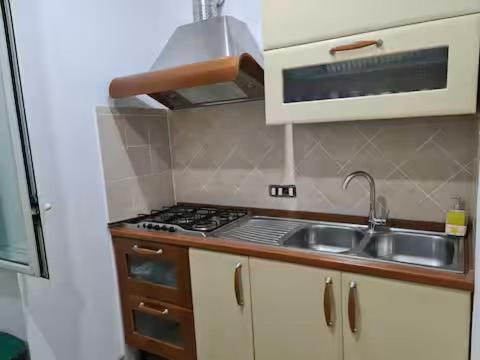 a small kitchen with a sink and a stove at Casadaema in Acerra