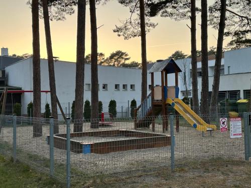 a park with a playground with a slide at Morski z ogródkiem in Pogorzelica