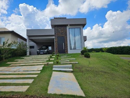 a house with a car parked in front of it at Ninho Verde Holiday Home in Quadra