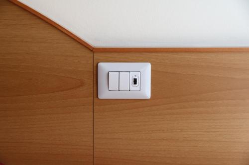 a electrical outlet on a wooden cabinet at Hotel Palladio in Milan