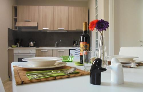 a kitchen counter with a table with a bottle of wine at Sopra Isola in Ioppolo Giancaxio
