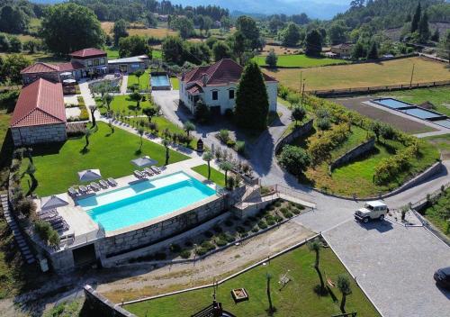 an aerial view of a house with a swimming pool at Quinta das Carvoeiras in Vieira do Minho