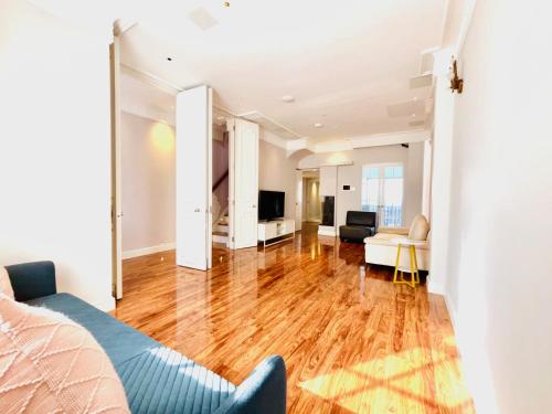 a living room with a hard wood floor at Elegant and Modern 3-Bedroom Victorian House in Westminster, London in London