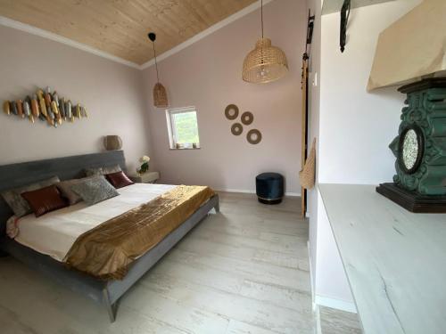 a bedroom with a bed and a clock on the wall at Portugals Infinity Eco Suite Resort in Tavira