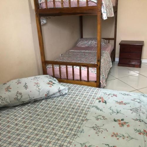 a bedroom with two bunk beds and a pillow at Pousada do Bene - Aluguel Casa in Guarujá