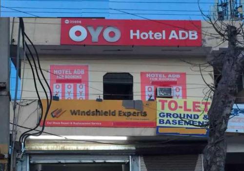 a hotel ad sign on the side of a building at OYO 81074 Hotel Adb in Faridabad