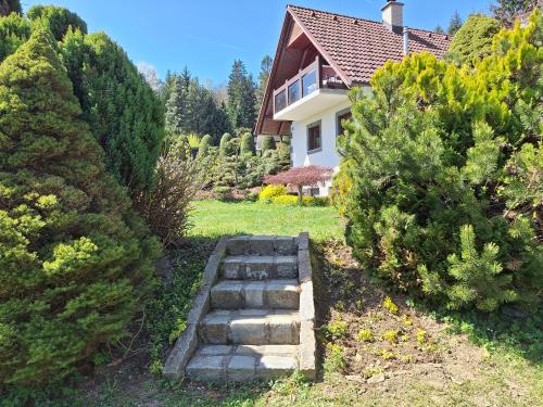 a garden with a stone path in front of a house at Pohorje Zen Garden in Pohorje