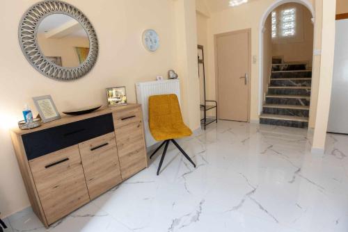 a room with a vanity with a mirror and a chair at Aegean Lesvos Maisonette in Mytilini