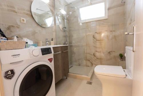 a washing machine in a bathroom with a shower at Aegean Lesvos Maisonette in Mytilini