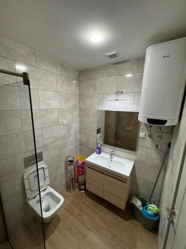a bathroom with a toilet and a sink at Residence Lux MD in Bar