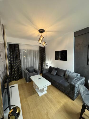 a living room with a couch and a table at Residence Lux MD in Bar