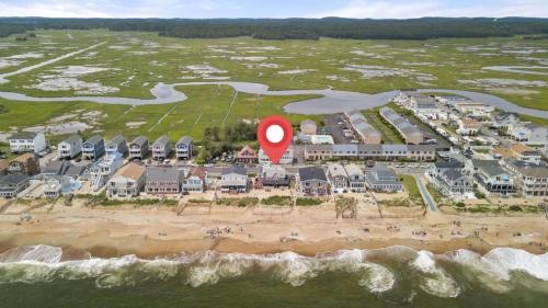 an aerial view of a resort on the beach with a red marker at Beachfront Parking Salisbury Beach Retreat in Salisbury