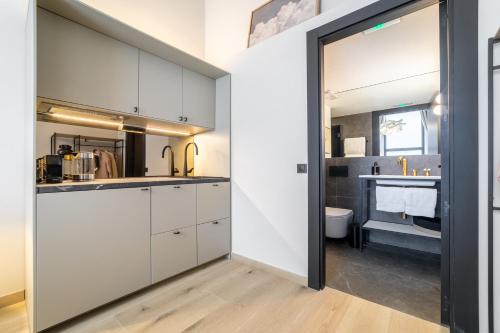 a kitchen with white cabinets and a sink at Casa Debod in Madrid