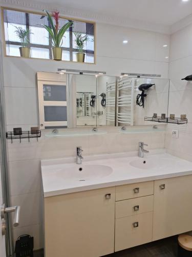 une salle de bain avec deux lavabos et un miroir dans l'établissement Nice Promenade des Anglais, à Nice