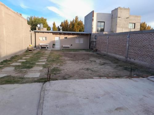 an empty parking lot in front of a building at Chalet arena in General Roca