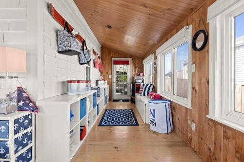 a kitchen with wooden walls and a wooden ceiling at The Wishbone Steps to Beach Bunk House in Newburyport