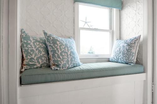 a window seat in a room with pillows on it at The Wishbone Steps to Beach Bunk House in Newburyport