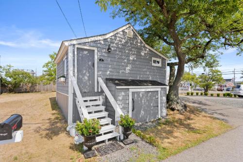 a tiny house with a door and a ladder at The Wishbone Steps to Beach Bunk House in Newburyport