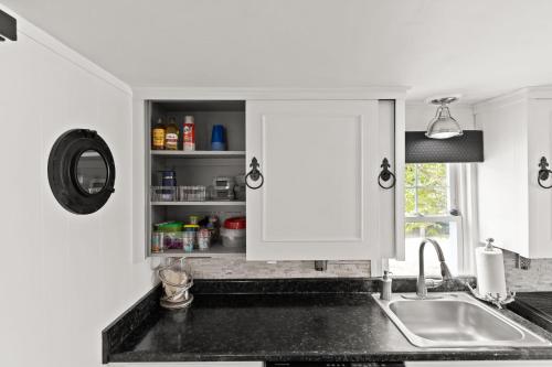 a kitchen counter with a sink and a window at The Wishbone Steps to Beach Bunk House in Newburyport