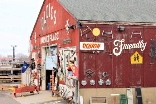 a red building with a man standing outside of it at The Wishbone Steps to Beach Bunk House in Newburyport