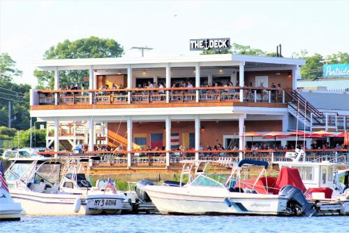 a restaurant with boats docked in front of a marina at The Wishbone Steps to Beach Bunk House in Newburyport