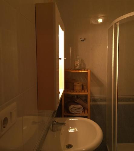a bathroom with a sink and a tub and a mirror at Playa de Boiro in Boiro