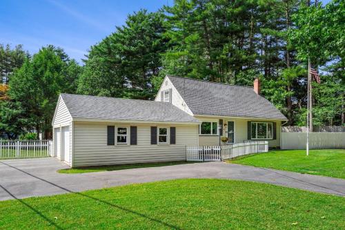 a small house with a white fence in a yard at Fenced-in Yard Work From Home Elwyn Park in Portsmouth