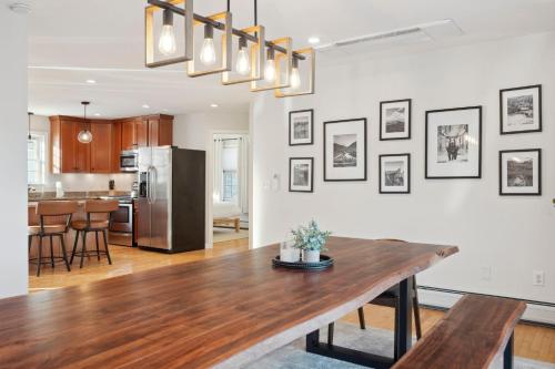 a kitchen and living room with a wooden table and a dining room at Winnisquam Landing Lakefront Firepit Deck in Tilton