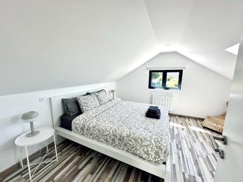 a white bedroom with a bed and a window at Casa Carlindo - Private Pool - Nature & Calm in Ferreira