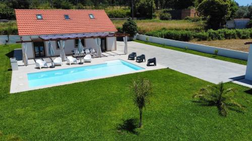 an aerial view of a house with a swimming pool at Casa Carlindo - Private Pool - Nature & Calm in Ferreira