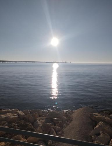 a body of water with the sun in the distance at Myriamare in Manfredonia