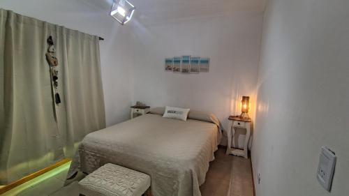 a small room with a bed and a window at Los Abuelos in Duggan