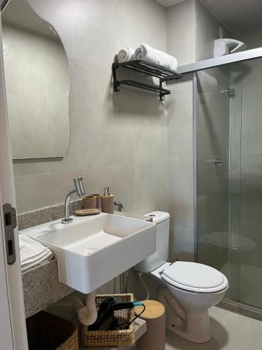 a bathroom with a sink and a toilet at Kauai Beach residence in Tamandaré
