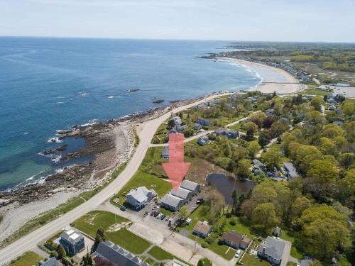 an aerial view of a beach with a red house at Serenity at Snug Harbor Ocean View Private Deck in Rye