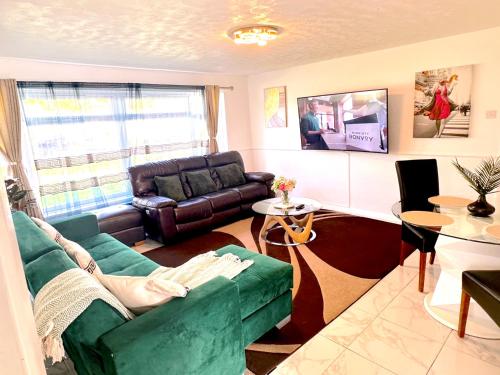 a living room with a couch and a table at Colchester City Luxury With Free Parking and 5 G WIFI in Colchester